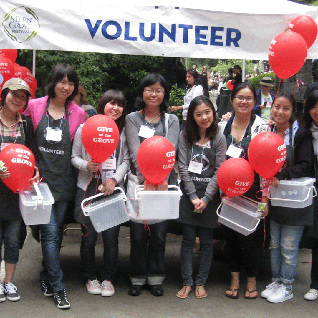 International student volunteers with red balloons