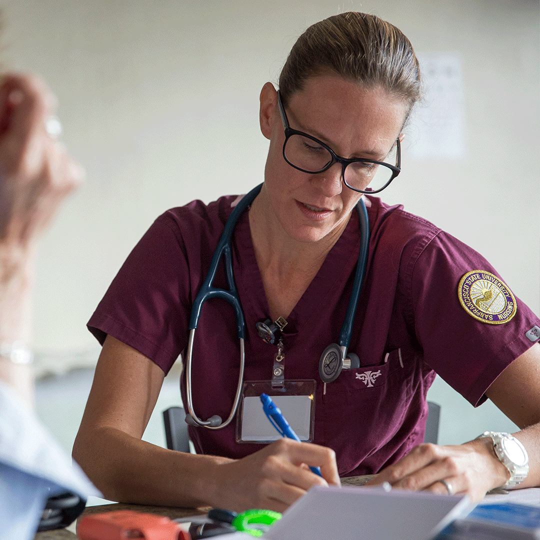 Family Nurse Practitioner takes notes while speaking with a patient