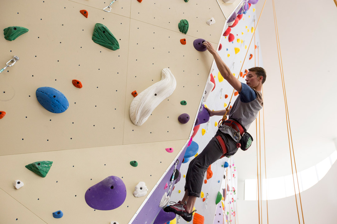 Student using rock climbing wall