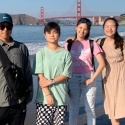 International students on the beach with the Golden Gate Bridge behind them