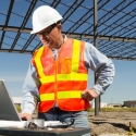 Construction project manager works on his laptop at the job site