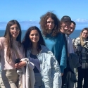 International students on a cliff above the ocean