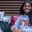 Student takes GE online courses outdoors
