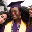 Three women graduates at Commencement