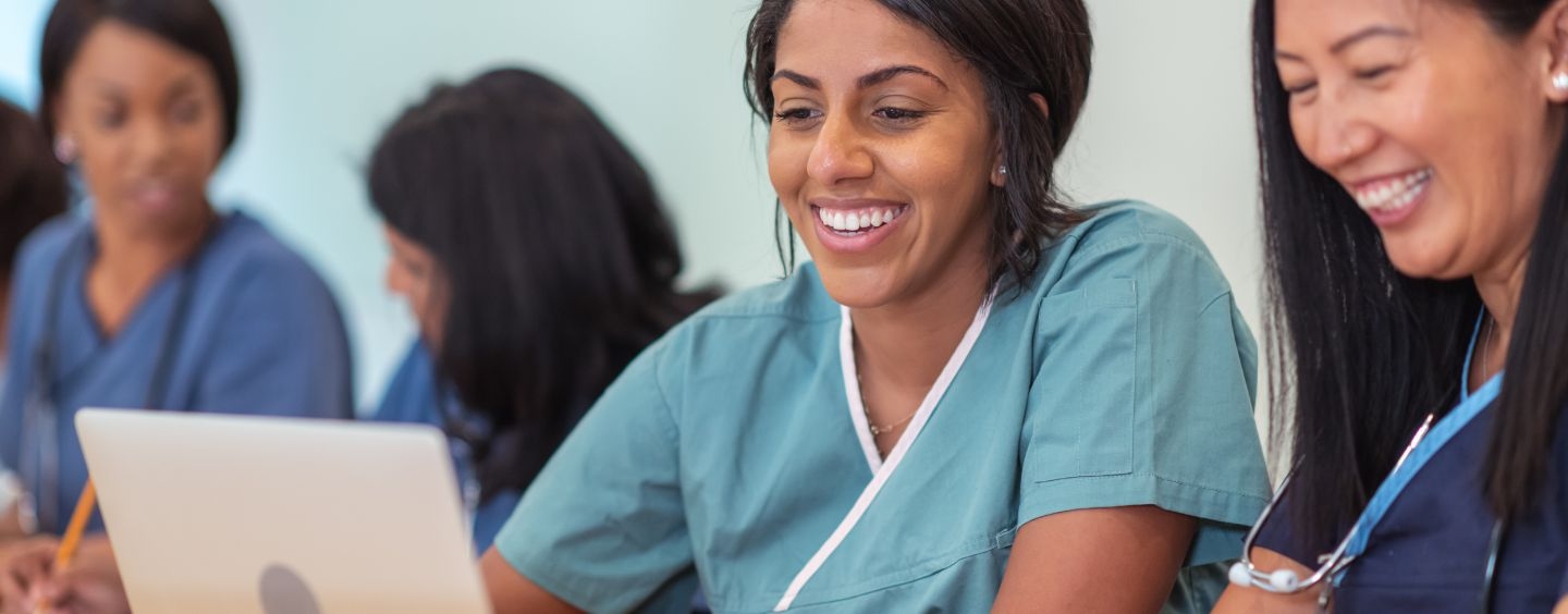 Medical assistant students in class look at computer