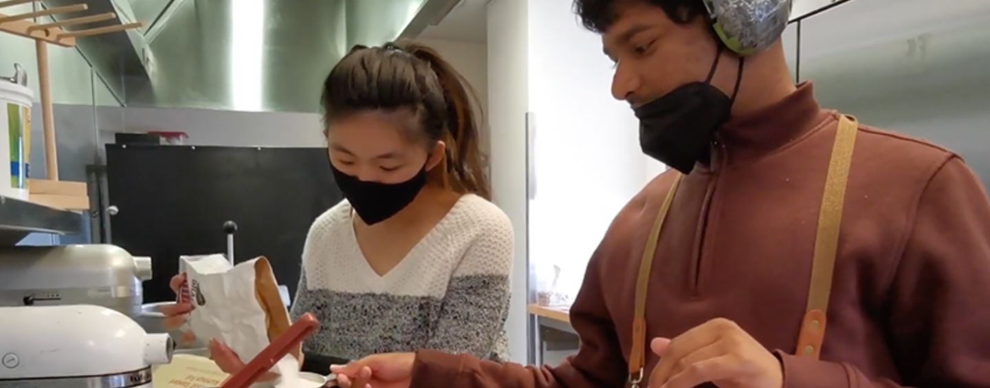 Peer mentor Judy Deng (left) and Inclusion Pilot Project student Ishaan Joshi prepare food in the Vista Room on campus