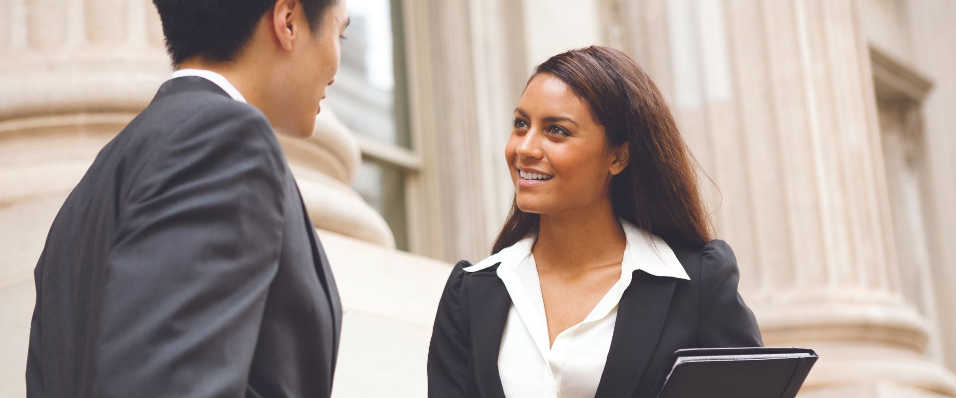 Paralegal professional speaks with a colleague outside the courthouse