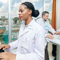 Clinical laboratory scientist using a computer