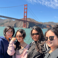 International students on a bay cruise with the Golden Gate Bridge behind them