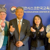 King Sejong Institute and SFSU representatives give finger hearts