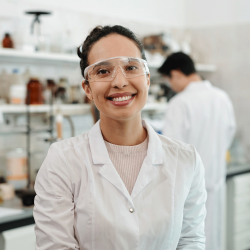 Pharmacist in a lab coat and protective eyewear