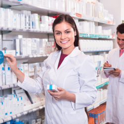 Pharmacy technician by the shelves