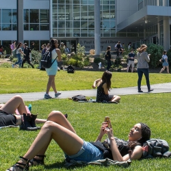 People sunbathing on the lawn at SFSU