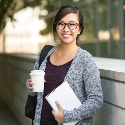 Student is prepared to take a test, with a notebook and a coffee