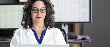 Medical billing and coding professional working on a computer