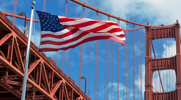 American flag flying in front of the Golden Gate Bridge